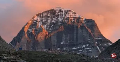 The North Face of Mount Kailash glowing gold at sunset.