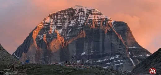 The North Face of Mount Kailash glowing gold at sunset.