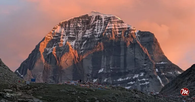 The North Face of Mount Kailash glowing gold at sunset.