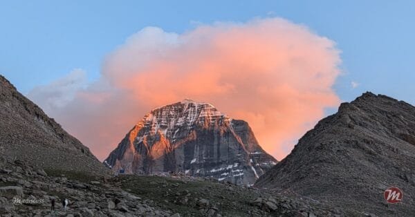 The North Face of Kailash in golden sunset light, orange cloud on the summit.